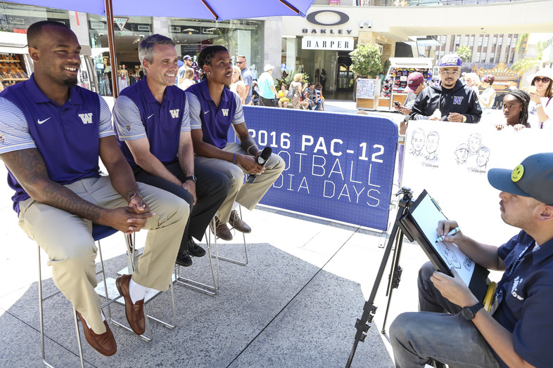 Darrell Daniels, Chris Petersen and Kevin King pose for the caricature artist. 