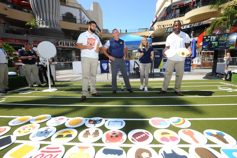 Steven Moore, Sonny Dykes, and DeVante Wilson figure out their emojis. 
