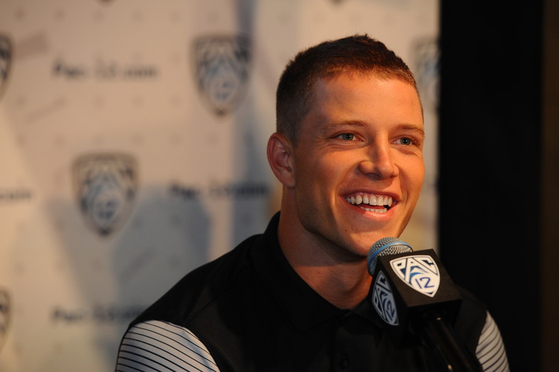 Stanford running back and record-breaker Christian McCaffrey chats with media members at the podium. 