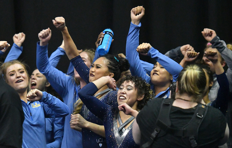 Picture Perfect! UCLA celebrates winning the national title after Christine Peng-Peng Lee helped raise the crown with a perfect 10.0 on beam.