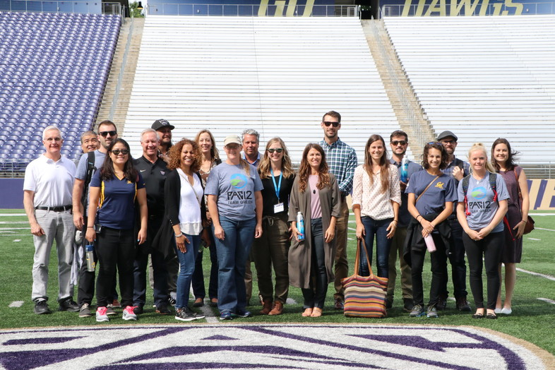 The Husky Stadium Sustainability Tour on Tuesday ends with a photo on the field.