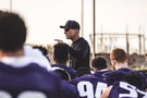 The Huskies huddle around head coach Chris Petersen following a practice in Southern California.