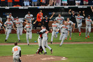 Oregon State baseball rushes the mound moments after Kevin Abel pitched a shutout vs. Arkansas in Game 3 to claim the program's third College World Series trophy.